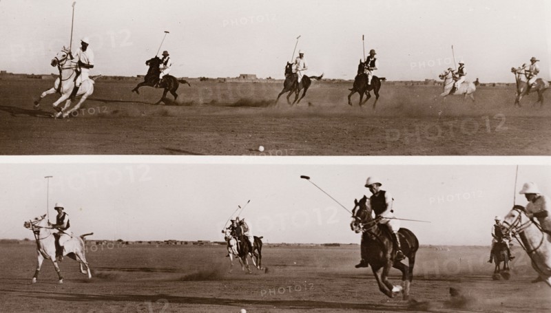 British officers play polo at Omdurman. A number of British military officers ride horses during a polo game in a wide, open space. Omdurman, Sudan circa 1910. Sudan, Eastern Africa, Africa.