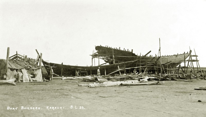 Boat builder's yard in Karachi. Two boats encased in scaffolding undergo construction at a boat builder's yard in Karachi. Karachi, India (Pakistan), circa 1910. Karachi, Sindh, Pakistan, Southern Asia, Asia.