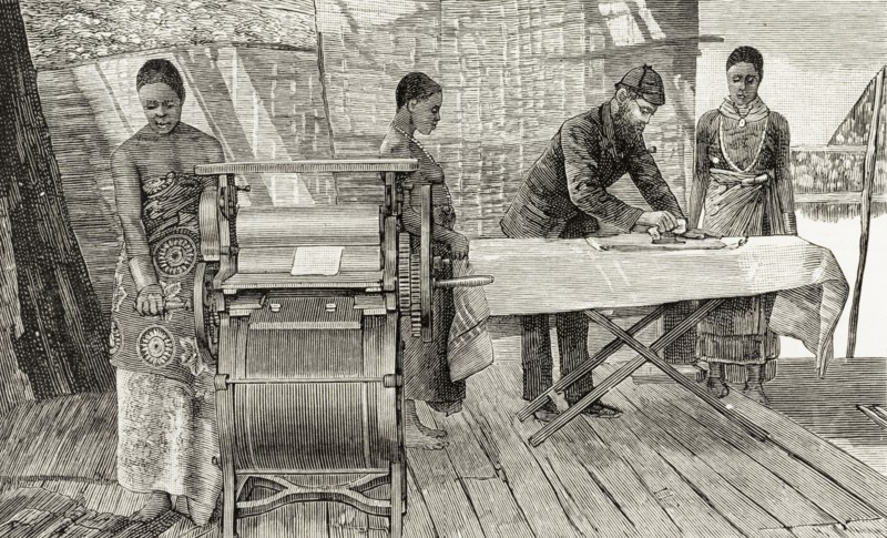 A missionary teaches chores to Malawian women. An illustration taken from a page of 'The Graphic' newspaper depicts a British missionary teaching domestic chores to a group of Malawian women. Two of the women watch as he irons a sheet of fabric, whilst another operates a sort of press, perhaps a mangle. Nyasaland (Malawi), circa 1889. Malawi, Southern Africa, Africa.