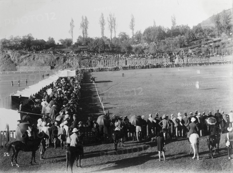 Spectators at a Durand Cup football match. An audience of mainly British spectators crowds the sidelines at a Durand Cup football match, India's oldest football tournament. More onlookers, both British and Indian, take shade beneath umbrellas as they watch the action from a hill overlooking the pitch. Simla (Shimla), India, circa 1895. Shimla, Himachal Pradesh, India, Southern Asia, Asia.