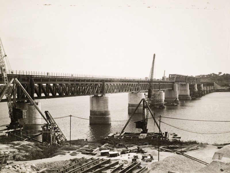 Benue Bridge in the final stages of construction. View of the Benue Bridge in the final stages of its construction. The truss bridge was built across the Benue River by Nigerian Railways. Oweto, Benue State, Nigeria, 24 March 1932. Oweto, Benue, Nigeria, Western Africa, Africa.