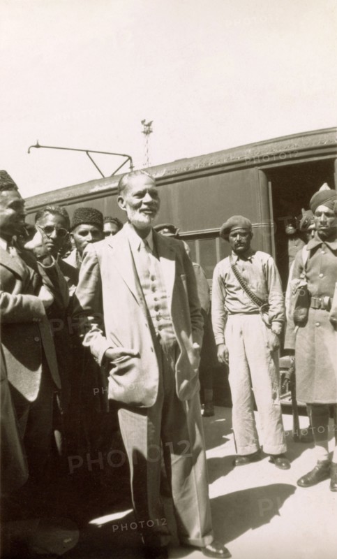 Muhammad Zafrulla Khan arrives at Rawalpindi. Muhammad Zafrulla Khan (1893-1985), Pakistan's first Foreign Minister, stands on a railway platform with a group of Indian dignitaries shortly after arriving at Rawalpindi station. Rawalpindi, Punjab, Pakistan, circa 1947. Rawalpindi, Punjab, Pakistan, Southern Asia, Asia.