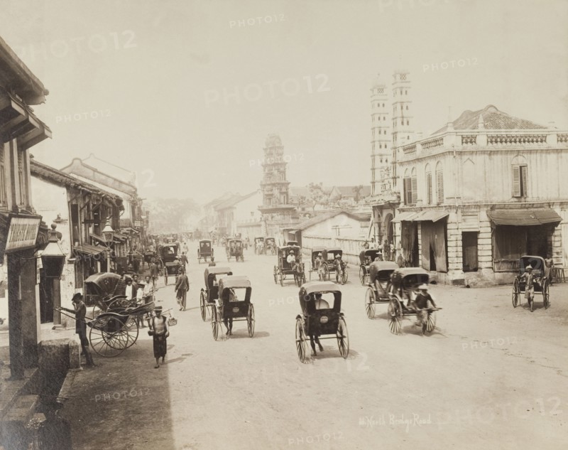 Rickshaws on South Bridge Road, Singapore. Rickshaws travel back and forth along Singapore's South Bridge Road. Singapore, Straits Settlements (Singapore), circa 1895. Singapore, Central (Singapore), Singapore, South East Asia, Asia.