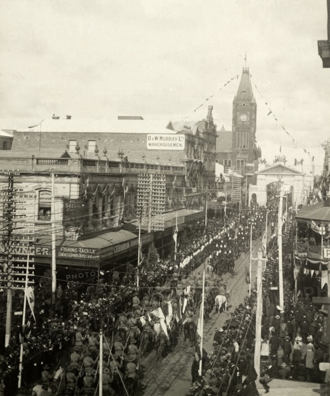 Royal welcome procession, Perth. Crowds line the streets as several military regiments file past Perth's town hall during a welcome procession for the Duke and Duchess of Cornwall and York (later King George V and Queen Mary). Perth, Australia, July 1901. Perth, West Australia, Australia, Australia, Oceania.