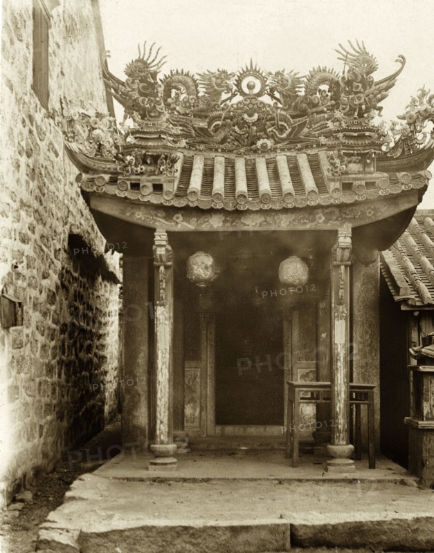 Ornate entrance to a Hong Kong Joss house. An ornate, pagoda-style roof, adorned with religious idols, decorates the doorway at the entrance to a 'Joss house'. Hong Kong, China, circa 1903. Hong Kong, Hong Kong, China, People's Republic of, Eastern Asia, Asia.