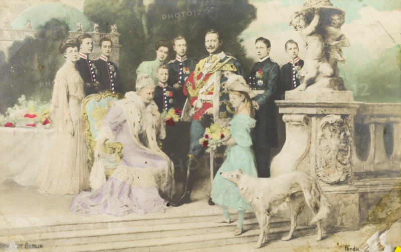 Portrait of the German royal family. Portrait of the German royal family, pictured outdoors on a terrace in the grounds of a royal residence. Kaiser Wilhelm II stands in the centre wearing full military regalia, whilst his wife, Auguste Viktoria, sits surrounded by their seven children and two daughters-in-law. Germany, 1906. Germany, Central Europe, Europe .