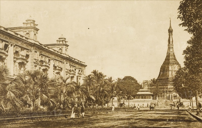 The Sule Pagoda from the south. View of the Sule Pagoda from the south. The pagoda stands at the end of a promenade lined with trees, with a large, grand building on the left. Rangoon (Yangon), Burma (Myanmar), circa 1920. Yangon, Yangon, Burma (Myanmar), South East Asia, Asia.