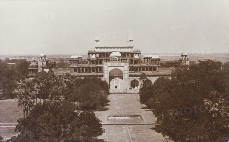 Emperor Akbar's tomb at Sikandra. View of Mughal Emperor Akbar's tomb (r.1556-1605) and the formal gardens that surround it. A decorative 'pishtaq' projects from the facade of the building, leading to the five-tiered tomb, which features pillared arcades with domed 'chattris', and culminates in an open terraced roof. Sikandra, United Provinces (Uttar Pradesh), India, circa 1923. Sikandra, Uttar Pradesh, India, Southern Asia, Asia.