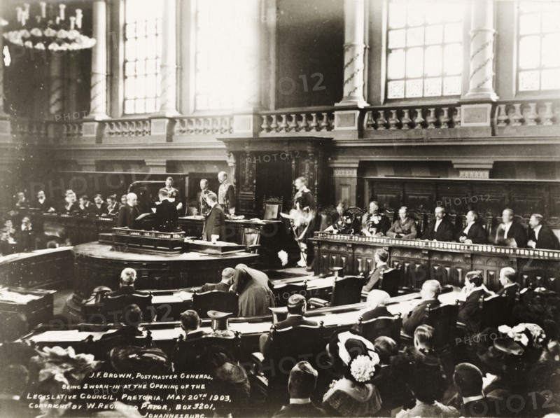 Opening of the Legislative Council in Pretoria. British dignitaries Sir Arthur Lawley, the Duke of Connaught, and General Lyttleton, swear in J.F. Brown, Postmaster-General, at the opening of the first Legislative Council of the Transvaal. The meeting took place inside the Ou Raadsaal (Old Council Chamber). Pretoria, South Africa, 20 May 1903. Pretoria, Gauteng, South Africa, Southern Africa, Africa.