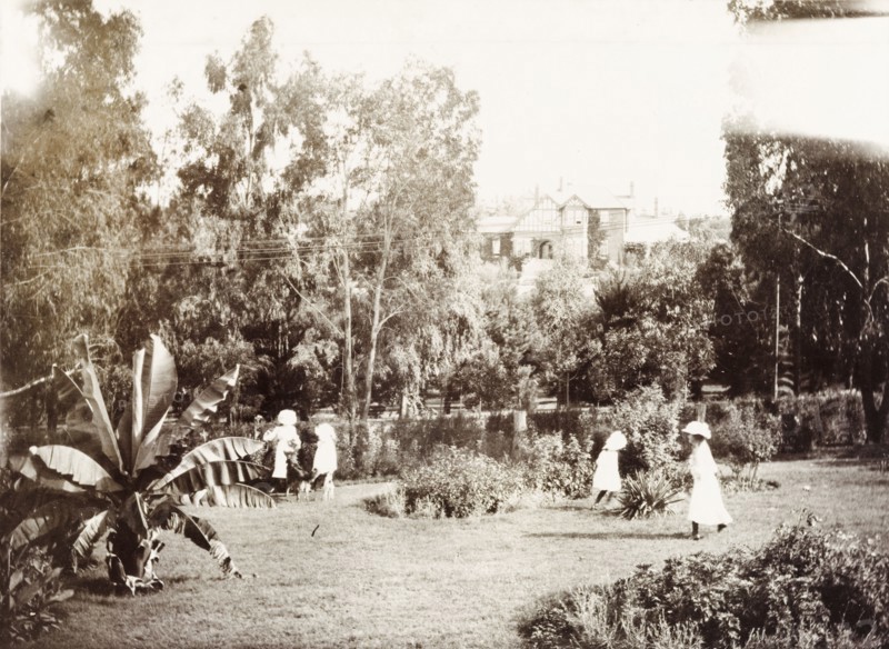 Children play in grounds of the Governor's residence. Cecilia and Ursula Lawley, the daughters of Sir Arthur Lawley, Lieutenant Governor of the Transvaal, play with two friends in the garden at 'Sunnyside', the residence of Lord Alfred Milner, High Commissioner and Governor of the Transvaal and Orange Free State. Johannesburg, South Africa, circa 1903. Johannesburg, Gauteng, South Africa, Southern Africa, Africa.