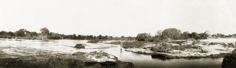 Rapids above Victoria Falls. Arthur Rhodes (brother of Cecil John Rhodes) paddles in the shallows of the Zambezi River above Victoria Falls. Matabeleland, Rhodesia (Matabeleland North, Zimbabwe), circa 1904., Matabeleland North, Zimbabwe, Southern Africa, Africa.