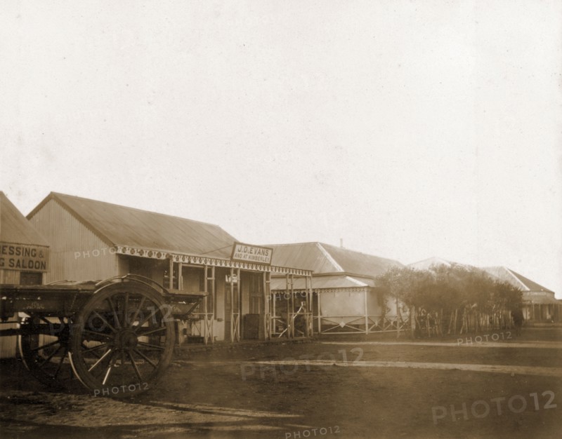 A street in Mafeking. A street in Mafeking, lined with low, colonial-style commercial buildings. Mafeking (Mafikeng), South Africa, circa 1896. Mafikeng, North West (South Africa), South Africa, Southern Africa, Africa.