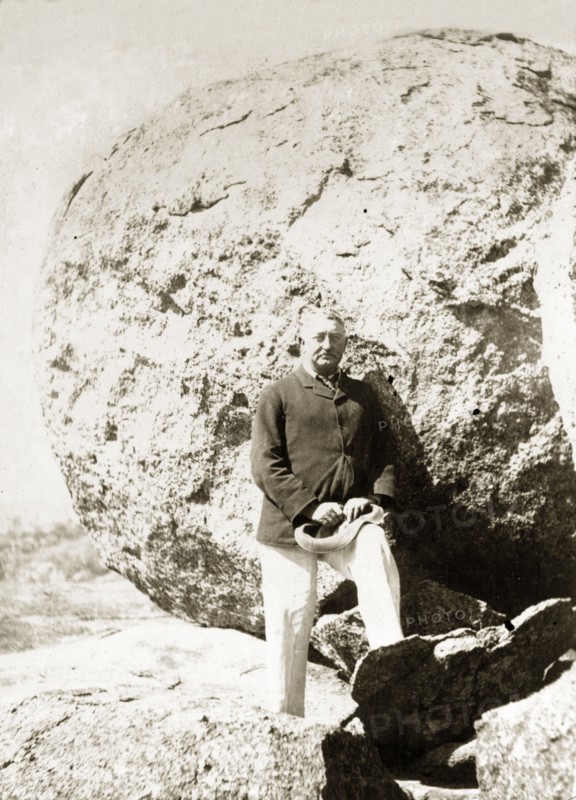 Cecil Rhodes at the Matopos Hills. Cecil Rhodes (1853-1902) stands amongst the granite boulders of the Matopos Hills. At his own request, Rhodes was eventually buried in these hills, at a spectacular site, Malindudzimu, which he christened 'World's View'. Near Bulawayo, Rhodesia (Zimbabwe), circa 1897., Matabeleland North, Zimbabwe, Southern Africa, Africa.