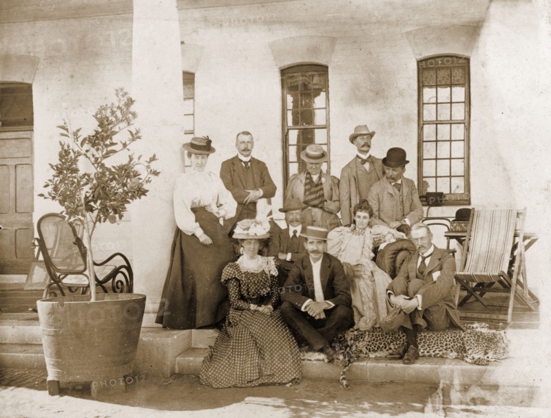 Guests at Government House in Bulawayo. A group of British administrators and their wives pose for an informal portrait on the veranda of Bulawayo's Government House. Bulawayo, Rhodesia (Zimbabwe), circa 1897. Bulawayo, Matabeleland North, Zimbabwe, Southern Africa, Africa.