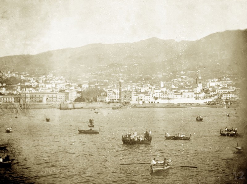 Funchal Bay, Madeira. Rowing boats bob about in Funchal Bay near to the coastal city of Funchal. Funchal, Madeira, circa 1897. Funchal, Madeira, Madeira Islands (Portugal), Atlantic Ocean, Africa.