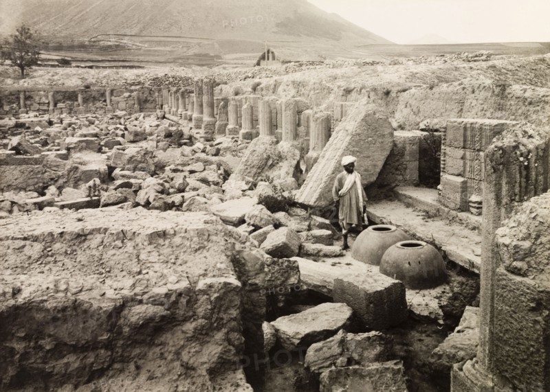 Avantisvami Temple at Avantipur. A man stands by two large clay pots amidst the ruins of Avantisvami Temple at Avantipur. The Hindu temple was built during the reign of King Avantivarman (r.855-883AD) and was dedicated to Lord Vishnu. Avantipur, Jammu and Kashmir State, India, circa 1925. Avantipur, Jammu and Kashmir, India, Southern Asia, Asia.