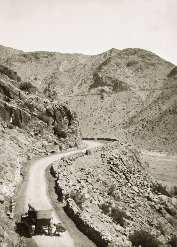 Near the site of Mollie Ellis' abduction. A motorcar pauses on a winding mountain road near the site where Mollie Ellis, the daughter of a British Army Commander, was held captive by a band of Afridi rebels during an incident that shocked the European colonial community. North West Frontier Province, India (Pakistan), circa 1928., North West Frontier Province, Pakistan, Southern Asia, Asia.