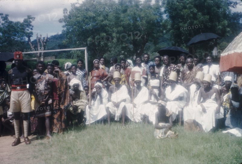 Priests at the Ngmayem festival. Priests dressed in white sit in a group at an annual Ngmayem harvest festival celebrated by the Manya Krobo people. Odumasi, Ghana, circa 1960. Odumasi, East (Ghana), Ghana, Western Africa, Africa.