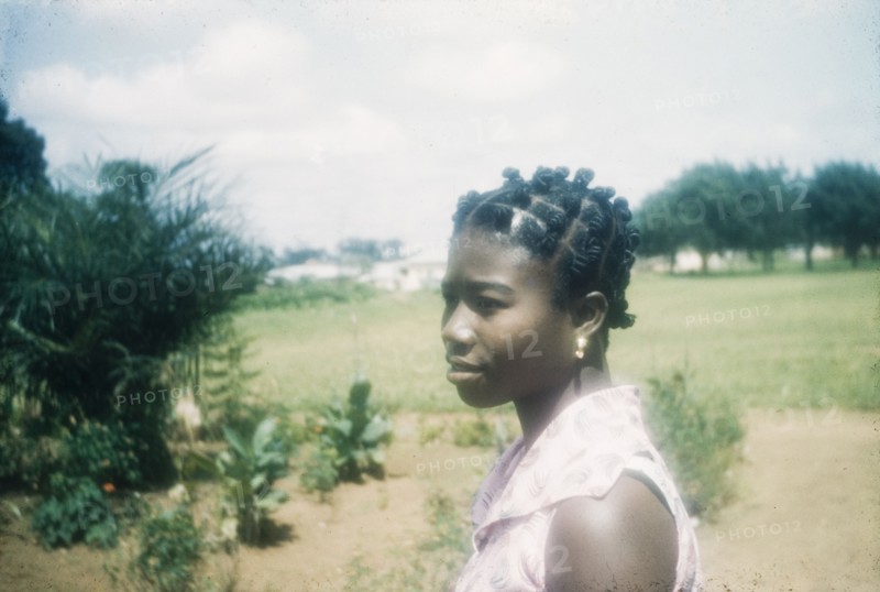 Ghanaian woman with a traditional hairstyle. Profile portrait of a Ghanaian woman wearing a traditional or 'candlewick' hairstyle. Bechem, Ghana, circa 1960. Bechem, Brong Ahafo, Ghana, Western Africa, Africa.