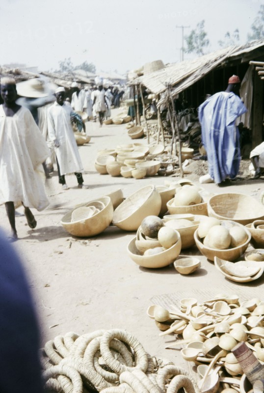 Gourd merchants, Kano. Traders sell a variety of gourd containers from stalls at a busy marketplace. Kano, Nigeria, February 1964. Kano, Kano, Nigeria, Western Africa, Africa.