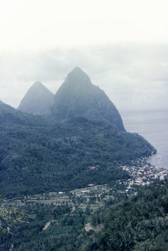 The Pitons, St Lucia. View of the Pitons, two mountains which form St Lucia's most famous landmark, with the coastal town of Soufriere nestling at their base. Soufriere, St Lucia, circa 1975. Soufriere, St Lucia, St Lucia, Caribbean, North America .