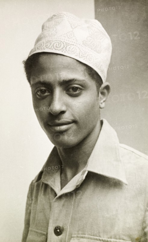 Muslim man wearing a kufi. Portrait of a young Muslim man wearing an embroidered kufi (cap). Lamu, Kenya, circa 1947. Lamu, Coast, Kenya, Eastern Africa, Africa.