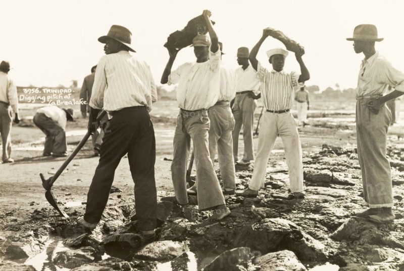 Labourers dig asphalt at the Pitch Lake. Labourers use pickaxes to extract lumps of asphalt from the Pitch Lake, a natural asphalt lake located on Trinidad's west coast. La Brea, Trinidad, circa 1935. La Brea, Trinidad and Tobago, Trinidad and Tobago, Caribbean, North America .