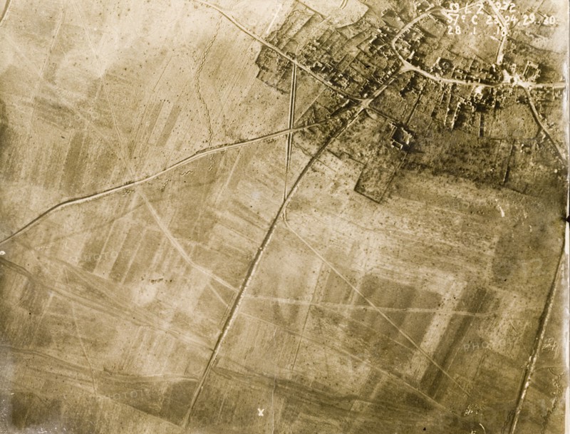 Aerial view of a bomb-damaged village. One of a series of British aerial reconnaissance photographs recording the positions of trenches on the Western Front during the First World War. The remains of a bomb-damaged village, surrounded by fields pockmarked with bomb craters. Nord-Pas de Calais or Picardie, France, 28 January 1918., Picardie, France, Western Europe, Europe .