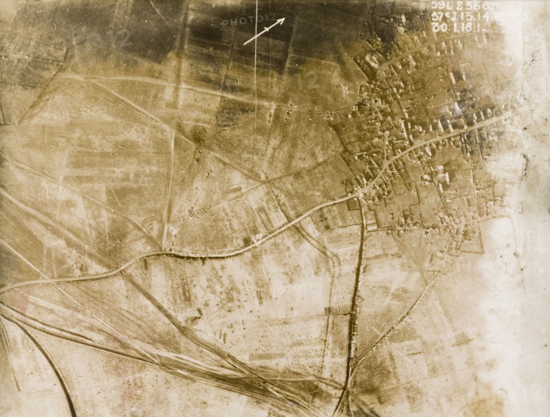 Aerial view of a bomb-damaged village. One of a series of British aerial reconnaissance photographs recording the positions of trenches on the Western Front during the First World War. The remains of a bomb-damaged village, surrounded by fields pockmarked with bomb craters. Nord-Pas de Calais or Picardie, France, 30 January 1918., Nord-Pas de Calais, France, Western Europe, Europe .