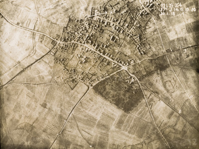 Aerial view of a bomb-damaged village. One of a series of British aerial reconnaissance photographs recording the positions of trenches on the Western Front during the First World War. The remains of a bomb-damaged village are surrounded by fields pockmarked with bomb craters. Nord-Pas de Calais or Picardie, France, 30 January 1918., Nord-Pas de Calais, France, Western Europe, Europe .