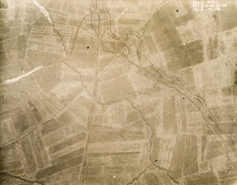Aerial view of a trench system. One of a series of British aerial reconnaissance photographs recording the positions of trenches on the Western Front during the First World War. An intricate trench system, probably British, zig-zags its way across a patchwork of fields. An original caption indicates no man's land as the area in the top right hand corner, bordered by dark lines of barbed wire protecting the front line to the south. Nord-Pas de Calais or Picardie, France, 17 February 1918., Nord-Pas de Calais, France, Western Europe, Europe .