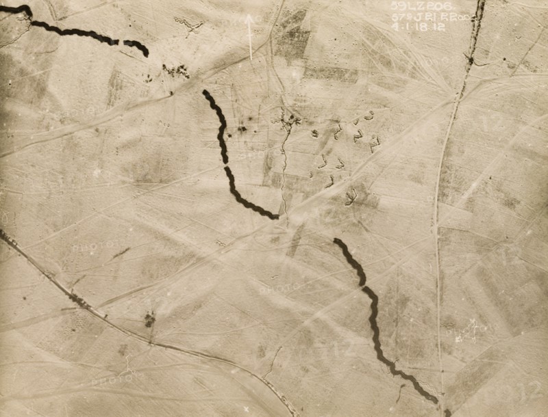 Aerial view of the Western Front under snow. One of a series of British aerial reconnaissance photographs recording the positions of trenches on the Western Front during the First World War. A thick belt of barbed wire runs north to south, contrasting sharply with the snow-covered battlefield. An original caption indicates the position of the 51st (Highland) Division of the British Army, stationed in a gap in the wire at the top of the image. Nord-Pas de Calais or Picardie, France, 4 January 1918., Nord-Pas de Calais, France, Western Europe, Europe .