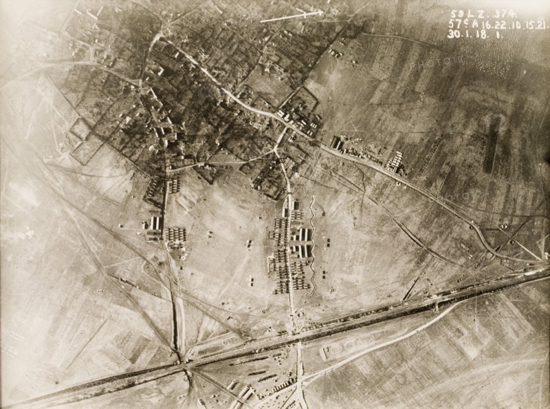British military camp in a ruined village. One of a series of British aerial reconnaissance photographs recording the positions of trenches on the Western Front during the First World War. A British military camp, based on the outskirts of a bomb-damaged village. An original caption identifies the positions of horse standings (long sheds) and smaller Nissen huts. Nord-Pas de Calais or Picardie, France, 30 January 1918., Nord-Pas de Calais, France, Western Europe, Europe .