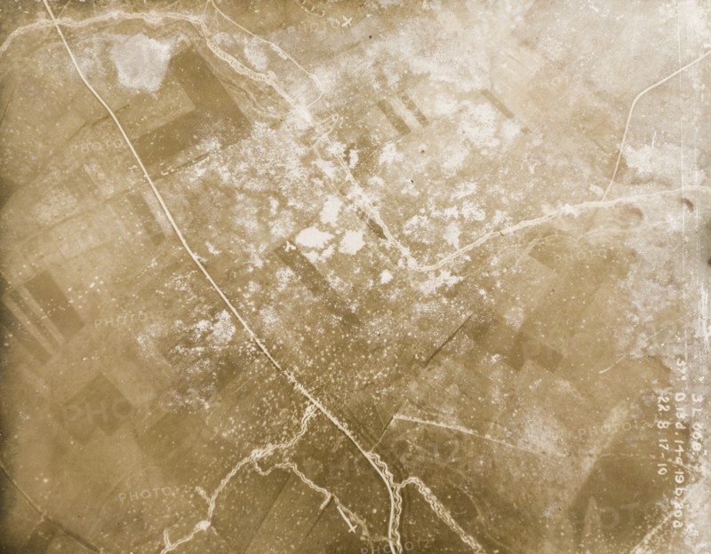 Fields riddled with trenches and bomb craters. One of a series of British aerial reconnaissance photographs recording the positions of trenches on the Western Front during the First World War. A road runs through a patchwork of fields riddled with trenches and bomb craters. Nord-Pas de Calais or Picardie, France, 22 August 1917., Nord-Pas de Calais, France, Western Europe, Europe .