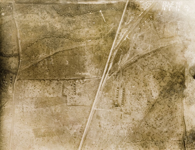 Aerial view of a bomb-damaged landscape. One of a series of British aerial reconnaissance photographs recording the positions of trenches on the Western Front during the First World War. The landscape surrounding a military camp is riddled with trenches and bomb craters. Nord-Pas de Calais or Picardie, France, 18 February 1918. France, Western Europe, Europe .