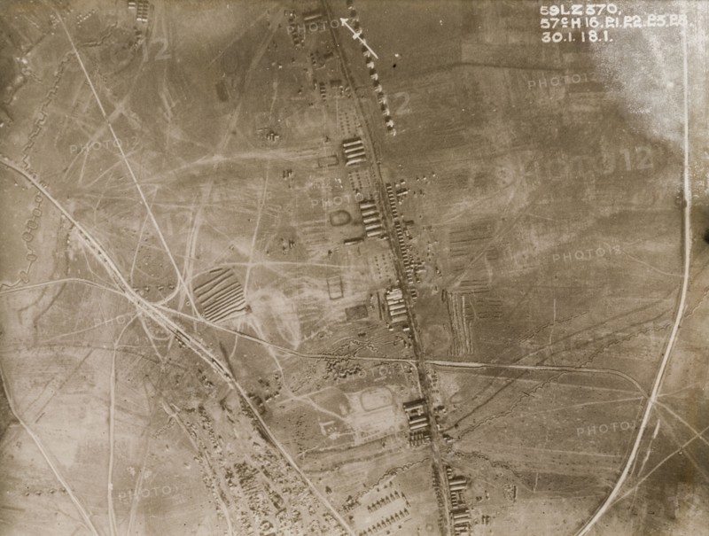 Aerial view of a military camp on the Western Front. One of a series of British aerial reconnaissance photographs recording the positions of trenches on the Western Front during the First World War. Trenches and transport tracks surround a military camp, probably British, based along a road running north to south. Nord-Pas de Calais or Picardie, France, 30 January 1918., Nord-Pas de Calais, France, Western Europe, Europe .