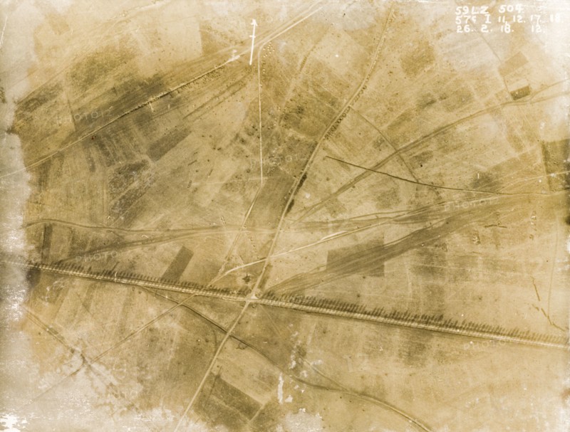Fields on the Western Front. One of a series of British aerial reconnaissance photographs recording the positions of trenches on the Western Front during the First World War. A line of poplar trees flank a prominently straight road, possibly one of several Roman roads in the region, casting long shadows across the surrounding fields. Nord-Pas de Calais or Picardie, France, 26 February 1918., Nord-Pas de Calais, France, Western Europe, Europe .