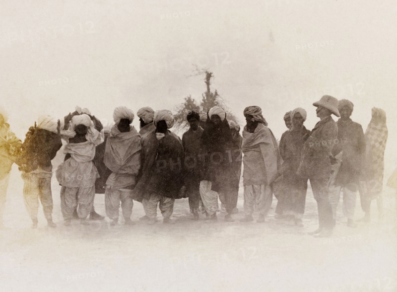 A line of 'zamindars'. Sir Henry Staveley Lawrence, Collector of Karachi, stands beside a line of turbaned Indian men who wear traditional dress. An original caption suggests the men are 'zamindars', landowners who shared taxes collected from tenants on their land with the British authorities. Sind, India (Sindh, Pakistan), circa 1910., Sindh, Pakistan, Southern Asia, Asia.
