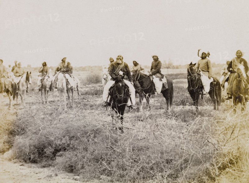 Indian men on horseback. A group of men in traditional Indian dress ride through a scrub landscape on horseback. Sukkur, Sind, India (Sindh, Pakistan), circa 1908. Sukkur, Sindh, Pakistan, Southern Asia, Asia.