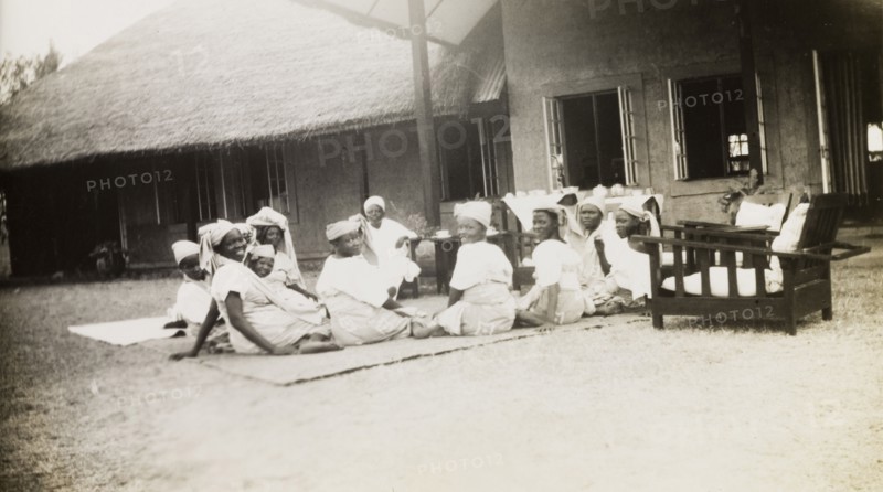 Nigerian schoolgirls attend a tea party. Female students of the Niger Middle School attend a tea party on the lawn of the Senior Education Officer's house. Bida, Nigeria, circa 1950. Bida, Niger, Nigeria, Western Africa, Africa.
