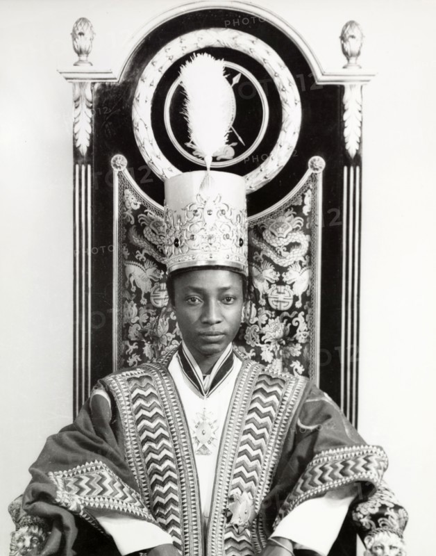 Edward Mutesa II, Kabaka of Buganda. Portrait of Edward Mutesa II, Kabaka (King) of Buganda, seated in an ornately decorated throne. Uganda, circa 1955. Uganda, Eastern Africa, Africa.