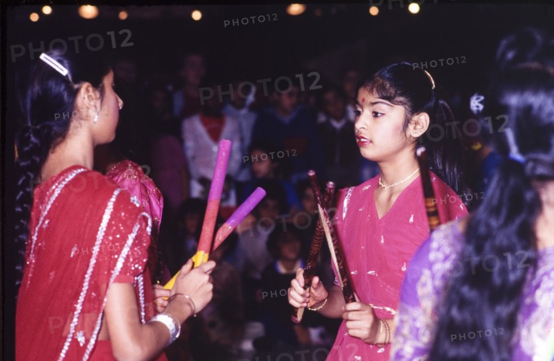 Girls celebrating Diwali. Two girls in traditional Indian dress celebrate Diwali, the Hindu festival of light, during a mela (fair) at the Commonwealth Institute. London, England, circa 1985. London, London, City of, England (United Kingdom), Western Europe, Europe .