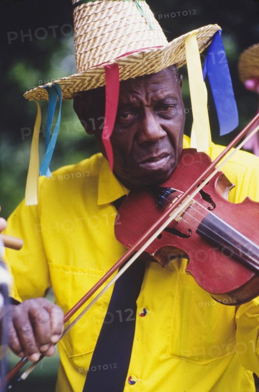 Violinist at the Caribbean Music Village. A musician plays a violin at the Caribbean Music Village, a cultural festival held at the Commonwealth Institute. London, England, 7-26 July 1986. London, London, City of, England (United Kingdom), Western Europe, Europe .