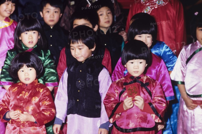 Children celebrating the Chinese New Year. Young children wear traditional Chinese dress during celebrations for the Chinese New Year. London, England, circa 1985. London, London, City of, England (United Kingdom), Western Europe, Europe .