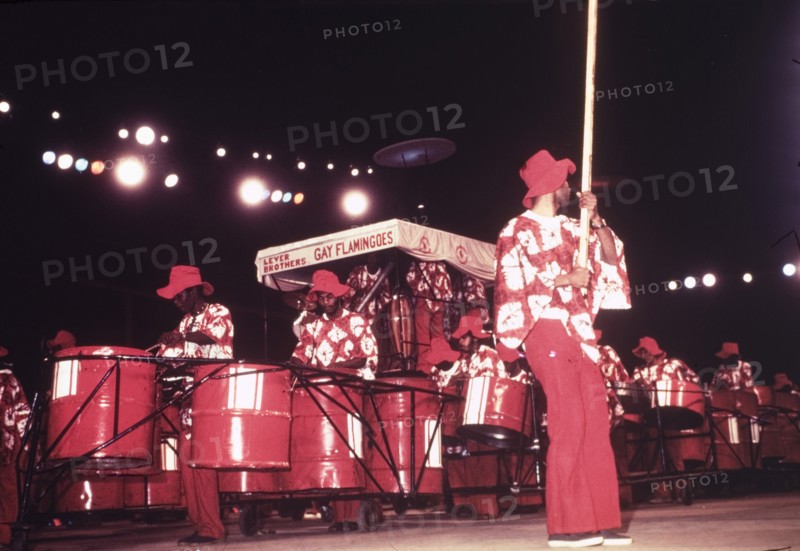 Lever Brothers Gay Flamingoes. A steel band called the 'Lever Brothers Gay Flamingoes' perform in costume during a cultural festival held at the Commonwealth Institute. London, England, circa 1980. London, London, City of, England (United Kingdom), Western Europe, Europe .