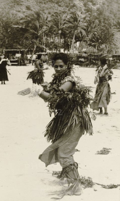 A Fijian dancer. A Fijian woman performs a traditional dance on a beach, dressed in ceremonial attire including a grass skirt worn over a 'sulu' (sarong). Fiji, 1935. Fiji, Pacific Ocean, Oceania.