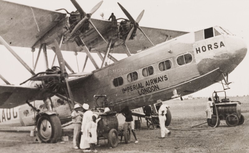 Refueling an Imperial Airways biplane, Kenya. Ground crew refuel an Imperial Airways long-range biplane, the G-AAUC Horsa, at a Kenyan airfield. Kenya, 1933. Kenya, Eastern Africa, Africa.