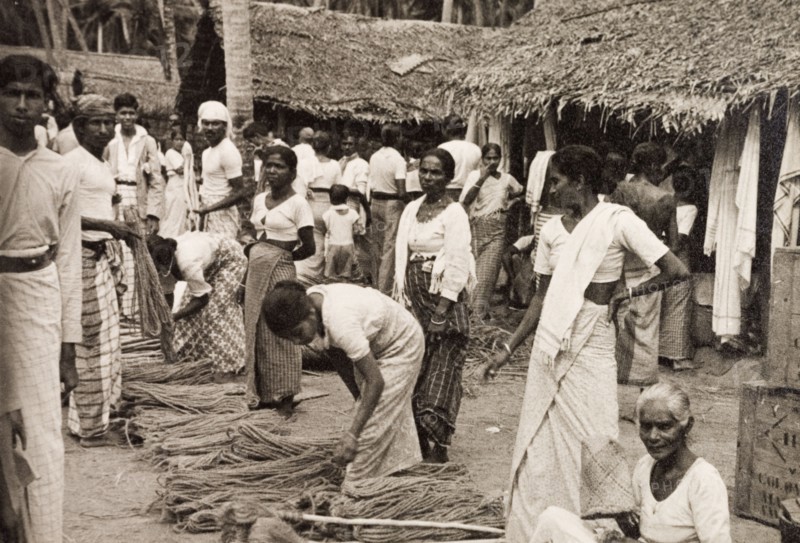 Rope sellers in Ceylon. Women sell bundles of rope at an outdoor market. Ceylon (Sri Lanka), 1936. Sri Lanka, Southern Asia, Asia.