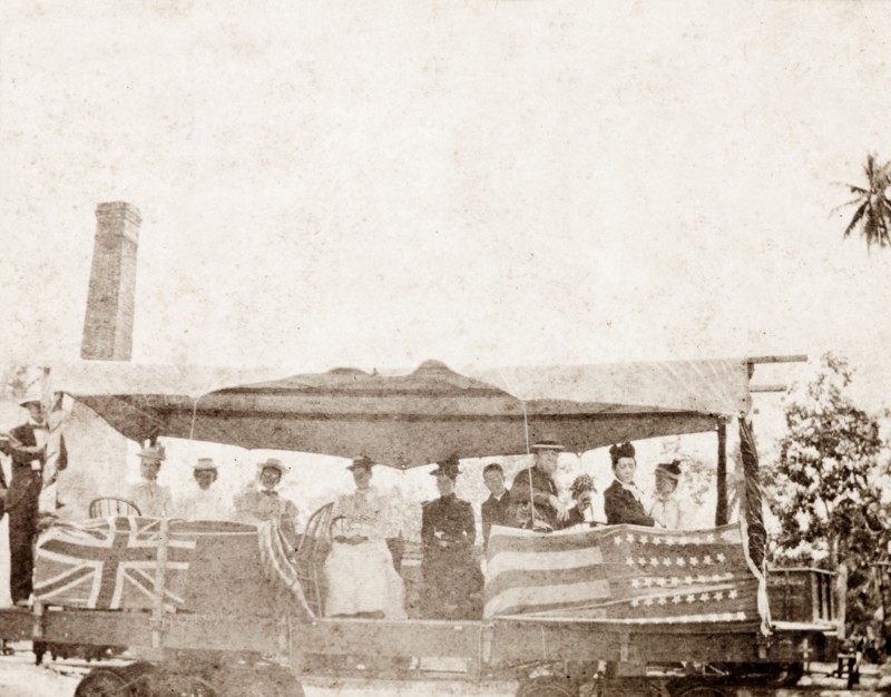 American missionaries in Jamaica. A group of American missionaries travels in an open rail carriage decorated with British and American flags. Jamaica, circa 1890. Jamaica, Caribbean, North America .