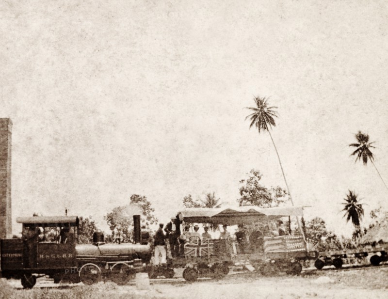 American missionaries in Jamaica. A group of American missionaries travels in an open rail carriage decorated with British and American flags. Jamaica, circa 1890. Jamaica, Caribbean, North America .